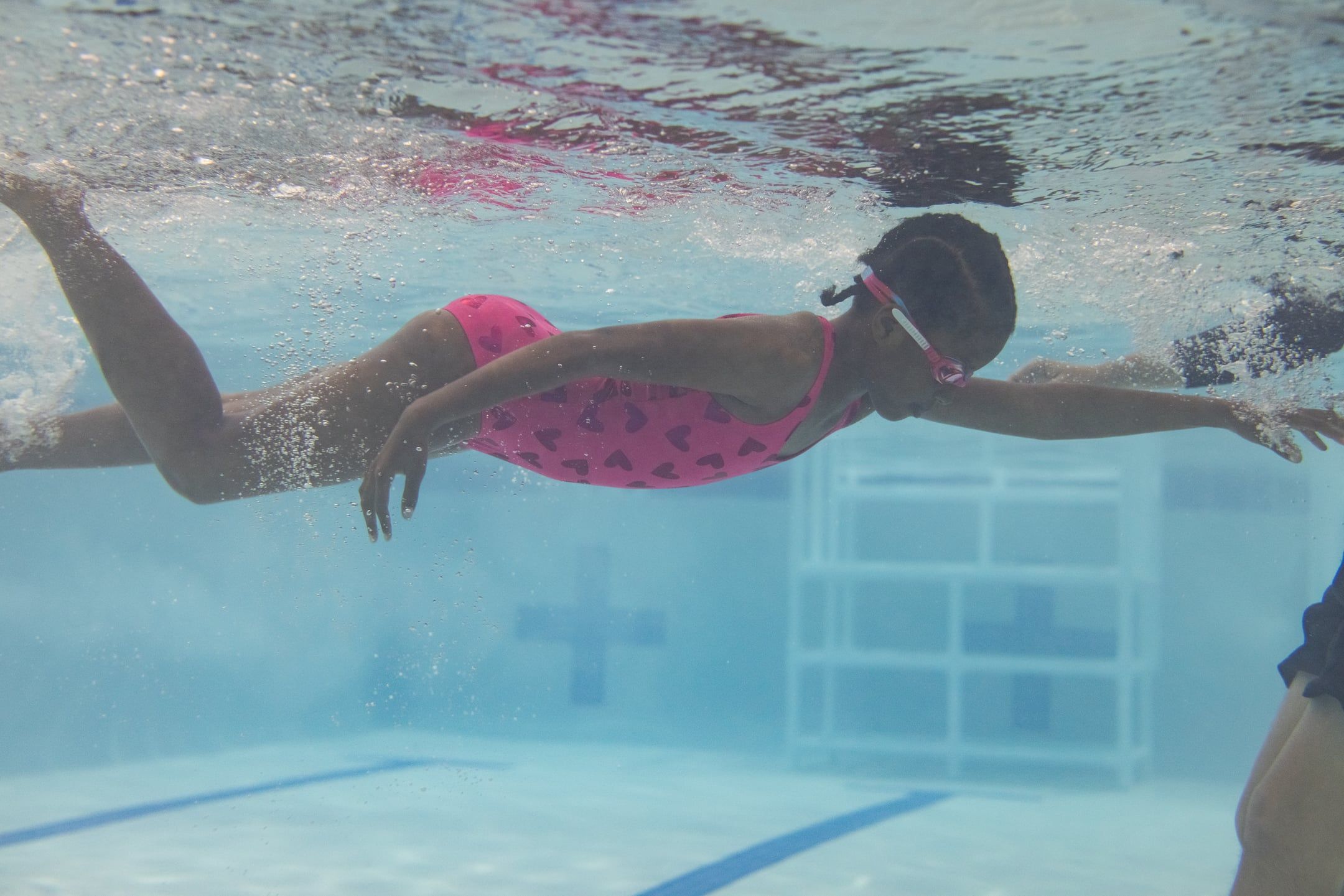 girl swimming under water